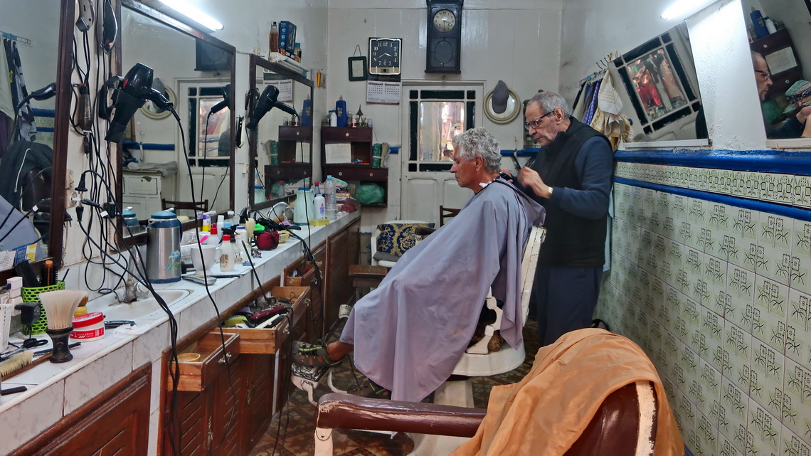 Alfred in a hair salon - cutting and grooming hair for two dollars