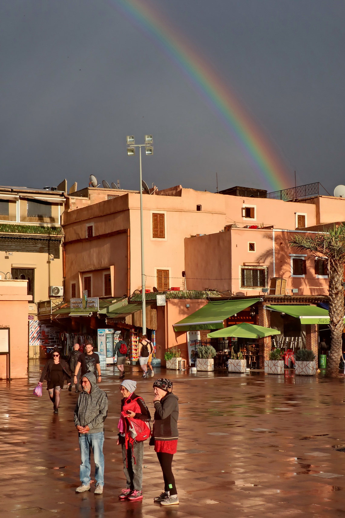 Hermann, Jutta and Marion with a rainbow on the Place des Ferblantiers