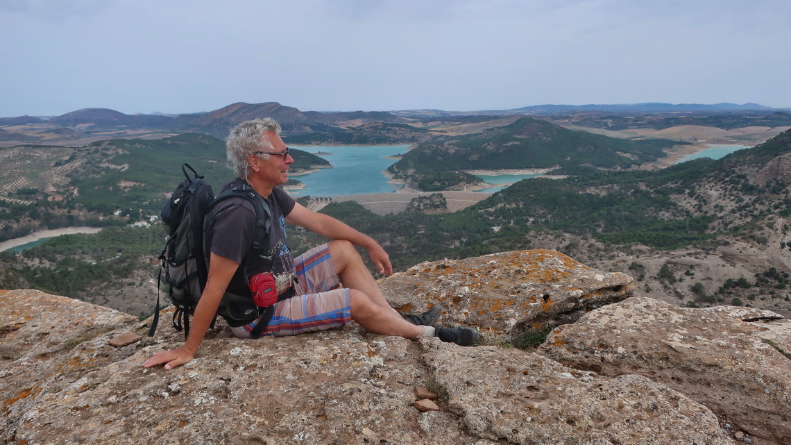 Alfred on top of 600 meters high Pico del Convento with Embalse del Guadalhorce in the back