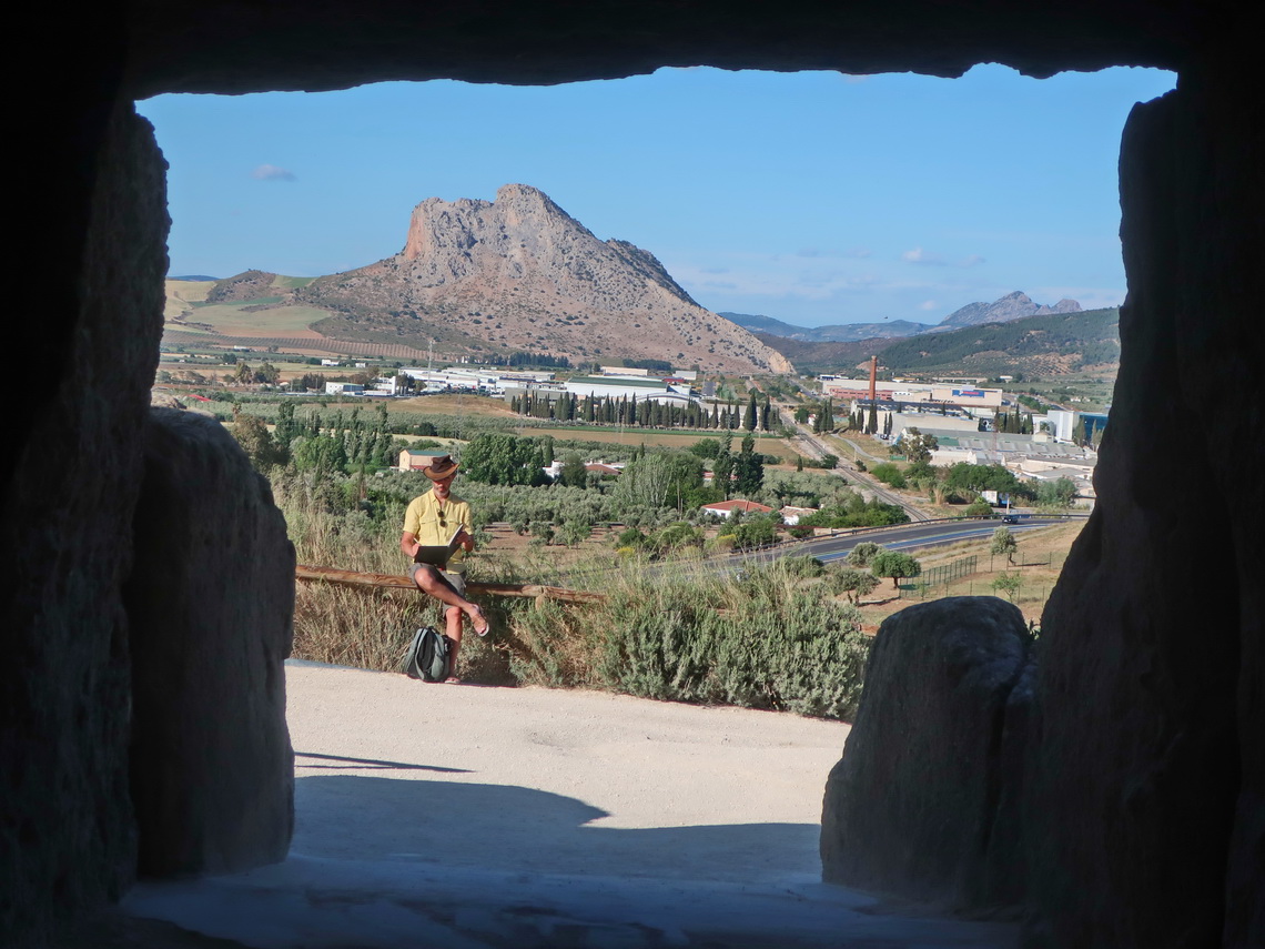 View from Dolmen de Menga to the holy mountain Peña de Los Enamorado which looks like the face a man lying down