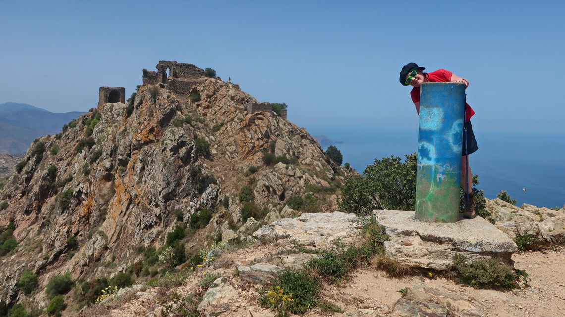 Marion on top of 670 meters high La Creu de Les Palomeres with Sant Salvador Saverdera in the back
