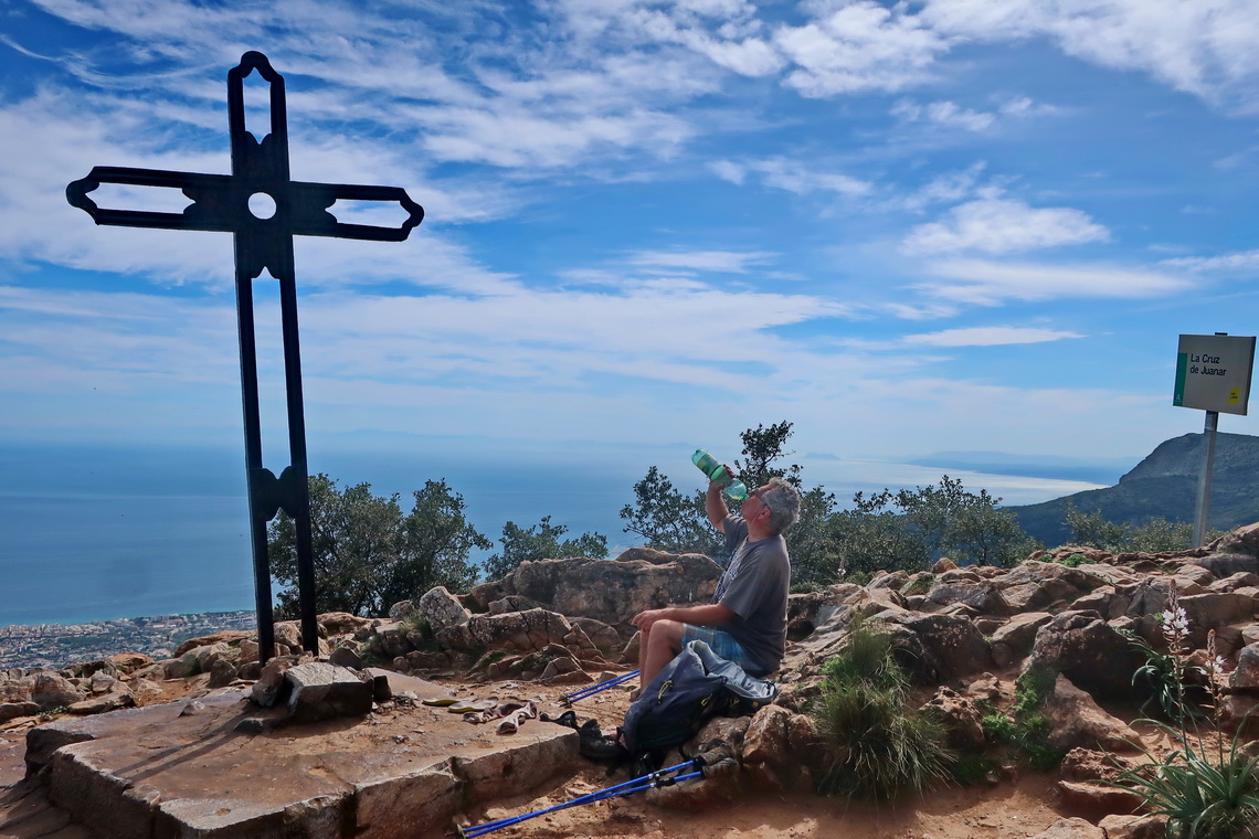 Alfred on the summit of Cruz de Juanar with Costa del Sol in the back