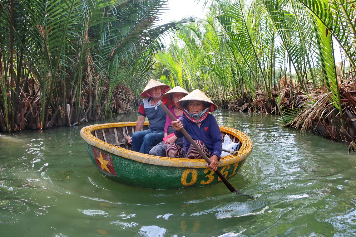 Hermann and Jutta in a tiny round boat driven by an elderly Lady