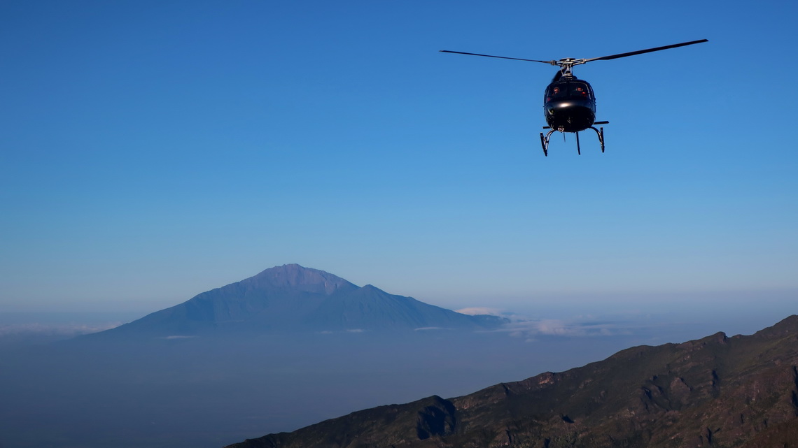 Approaching helicopter with Mount Meru on Shira Cave Camp