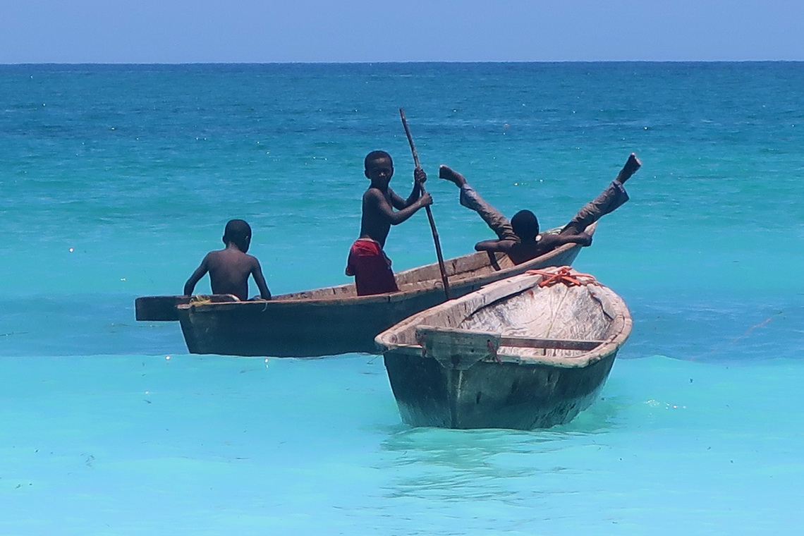 Boys playing in a little boat