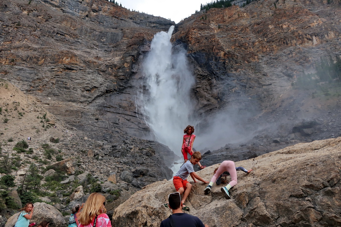 Kids including Rosemarie climbing a rock in front of the Takakkaw Falls in the Yoho National Park