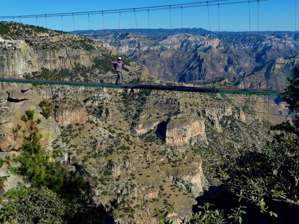 Marion on a suspension bridge with the main canyon in the background