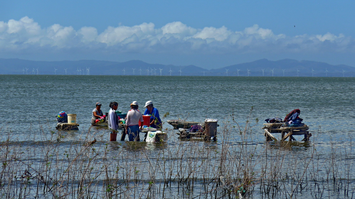Washing clothes in the lake near San Jose del Sur - Note the modern wind power stations. But we saw some overthrown (violent storm? sabotage? poor workmanship?)