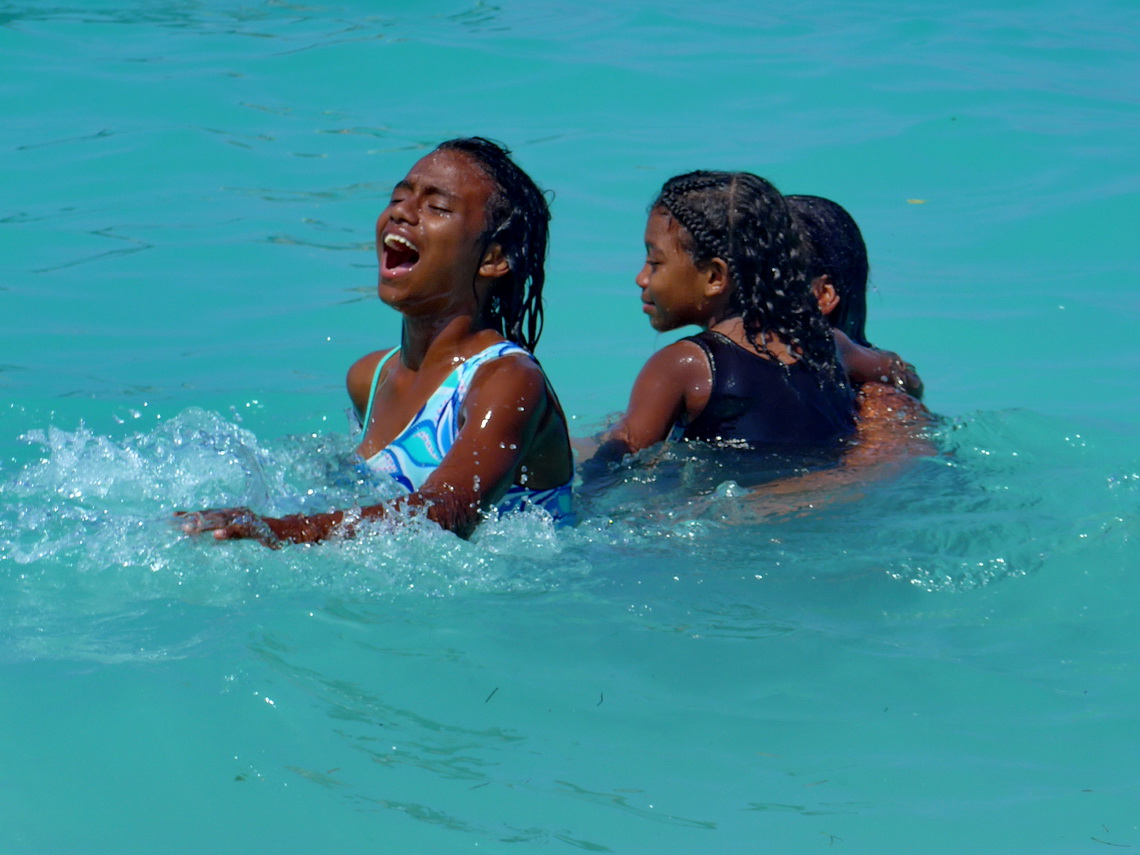 Girls enjoying the warm water of the Caribbean Sea