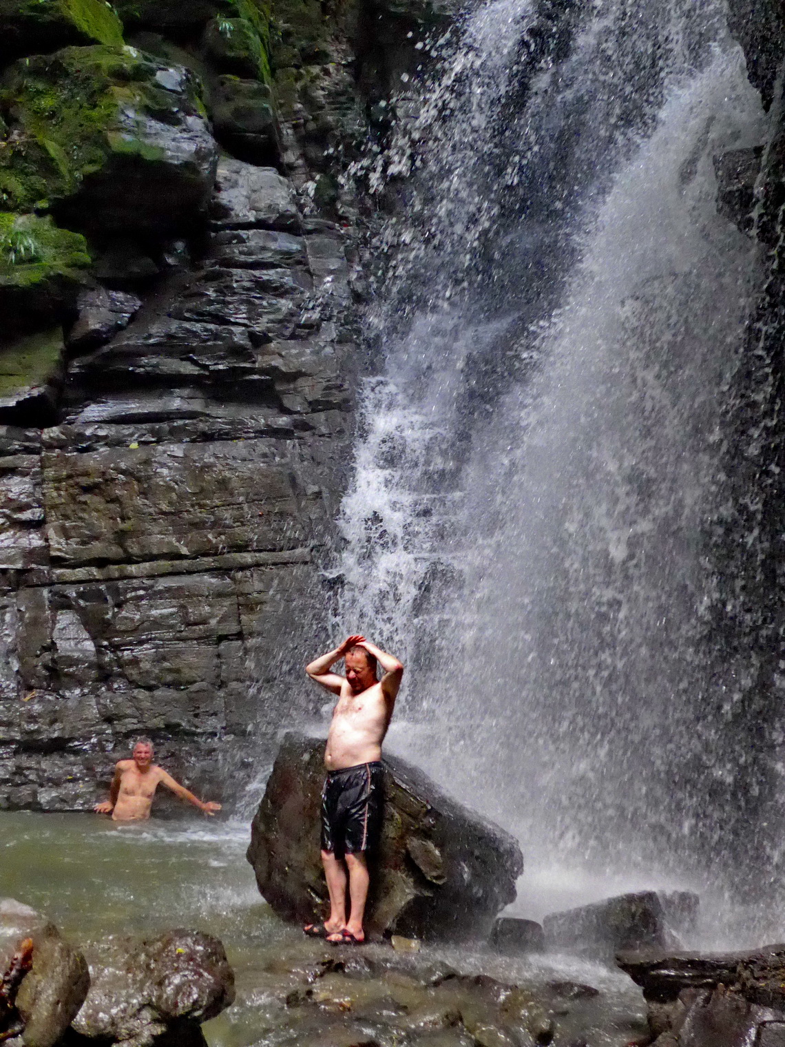 Enjoying the cold water of the waterfall Cascada de Latas