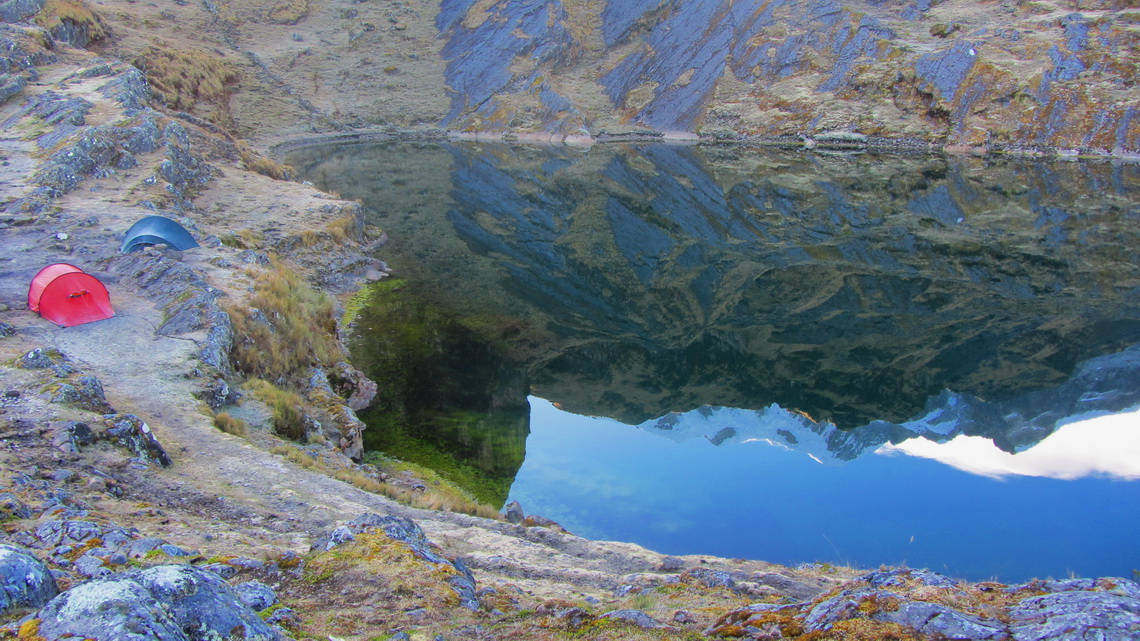 Sunrise at Laguna Chillata with our tents and Pico Schulze mirrored in the lake