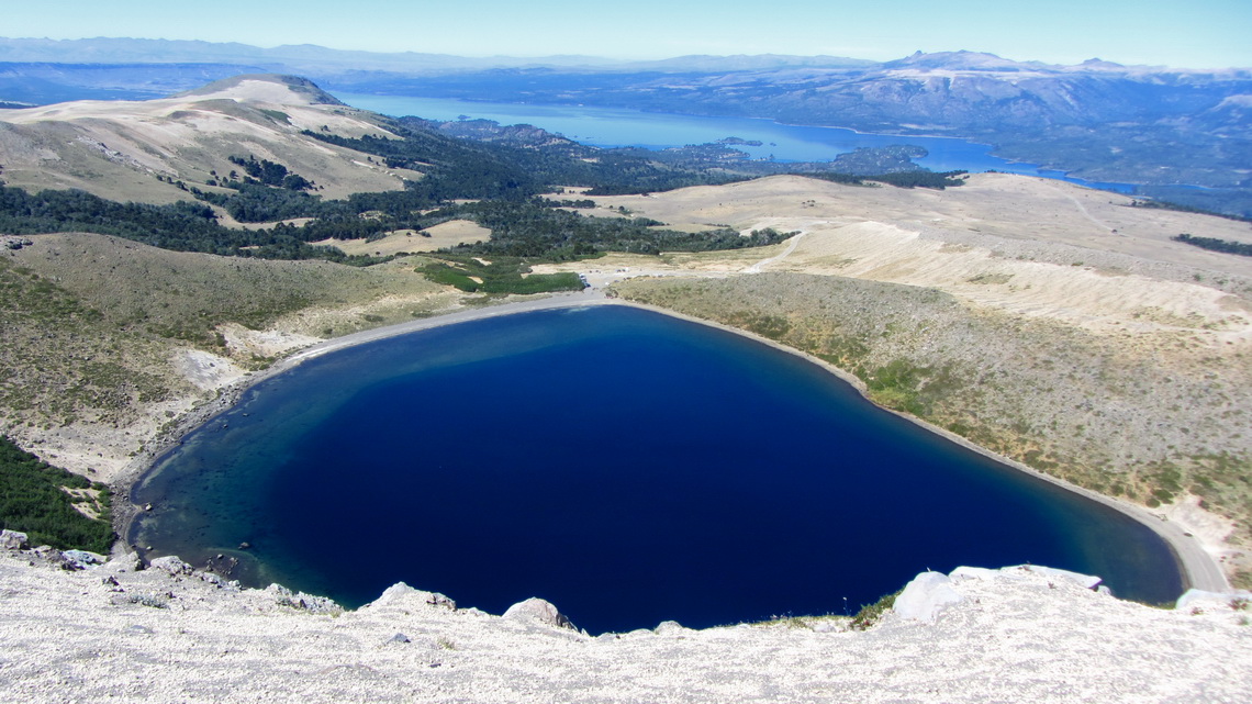 The crater lake of Volcan Batea Mahuida and Lago Alumine in the background