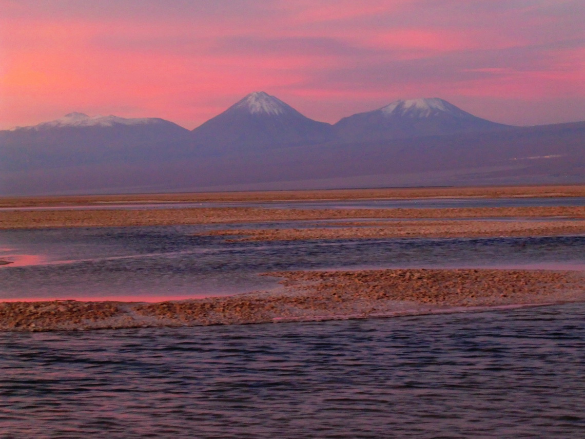Laguna Chaxi with volcanoes Licancabur and Juriques in the last daylight