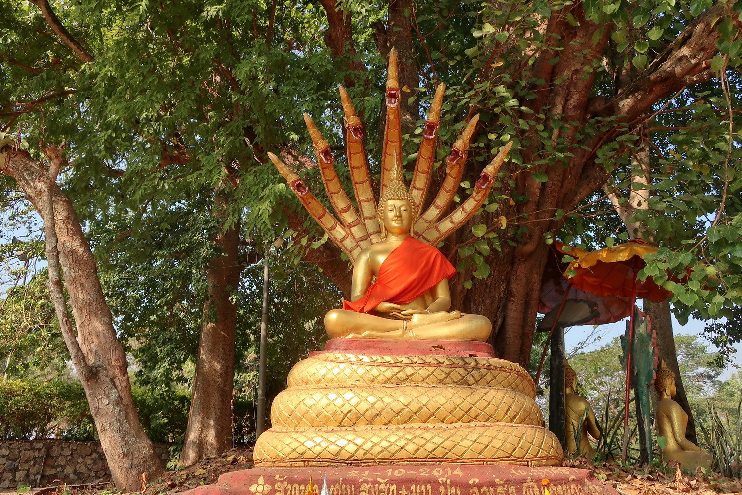 Naga Buddha Statue close to Wat That Kuang in Luang Prabang