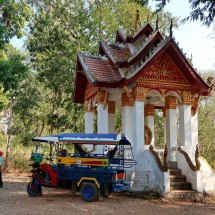Little temple with a tuk-tuk on the viewpoint of the mouth of Nam Khan river into Mekong