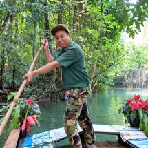 Our Captain on the bamboo boat to the water cave on top of the Kuang Si Waterfalls