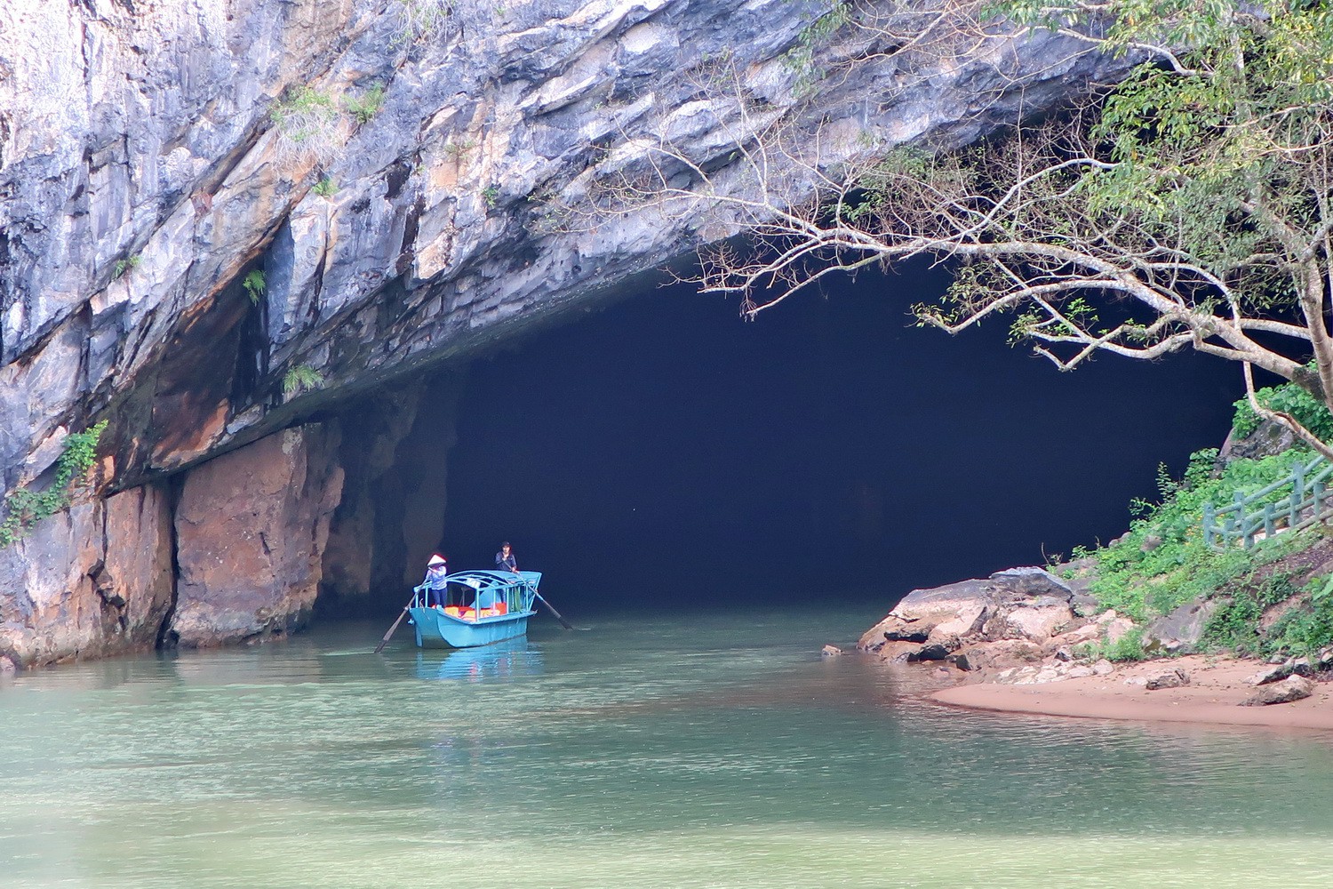 Boat leaving Phong Nha Cave which is the largest known river cave on earth