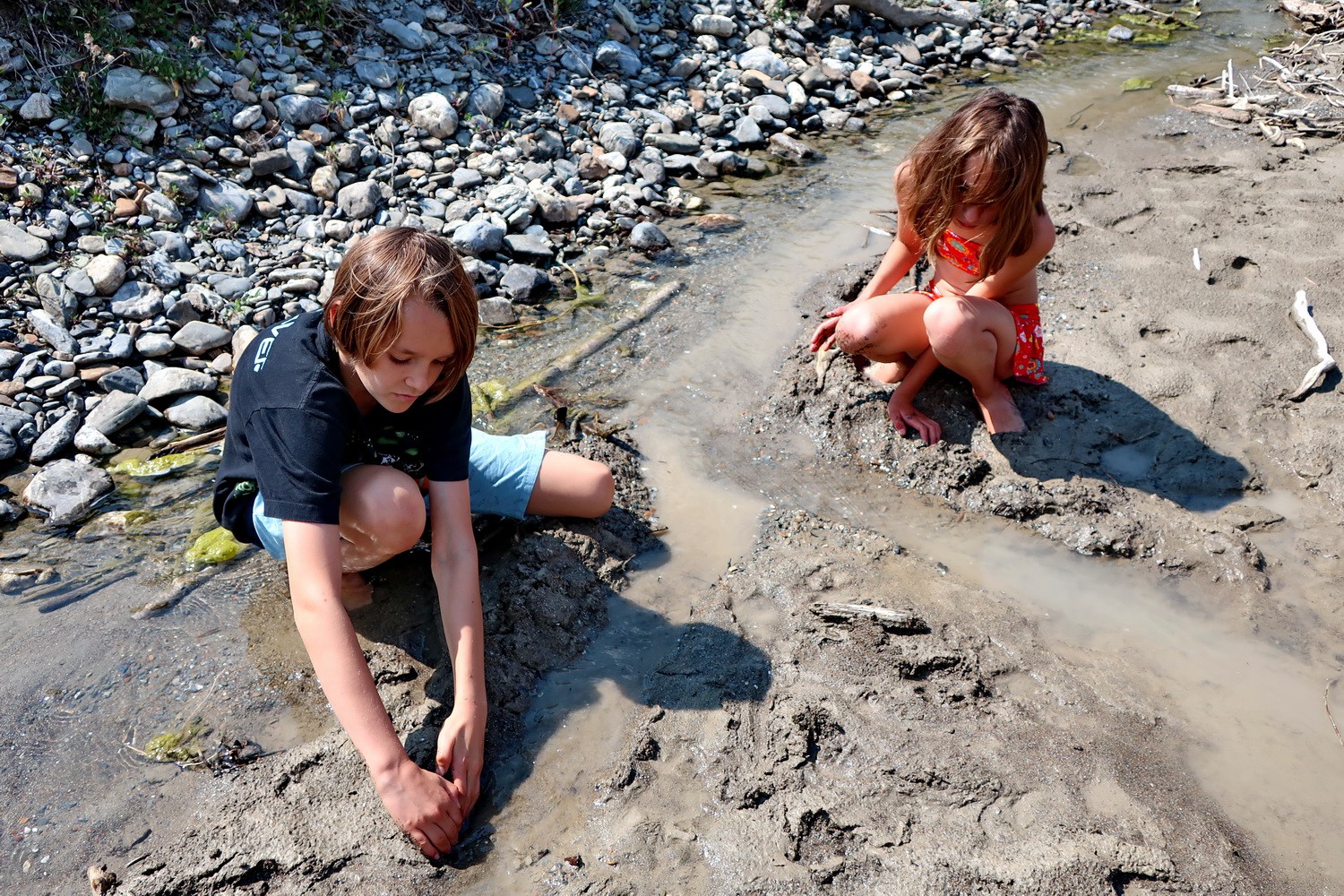 Kids playing in the mud of Kicking Horse River