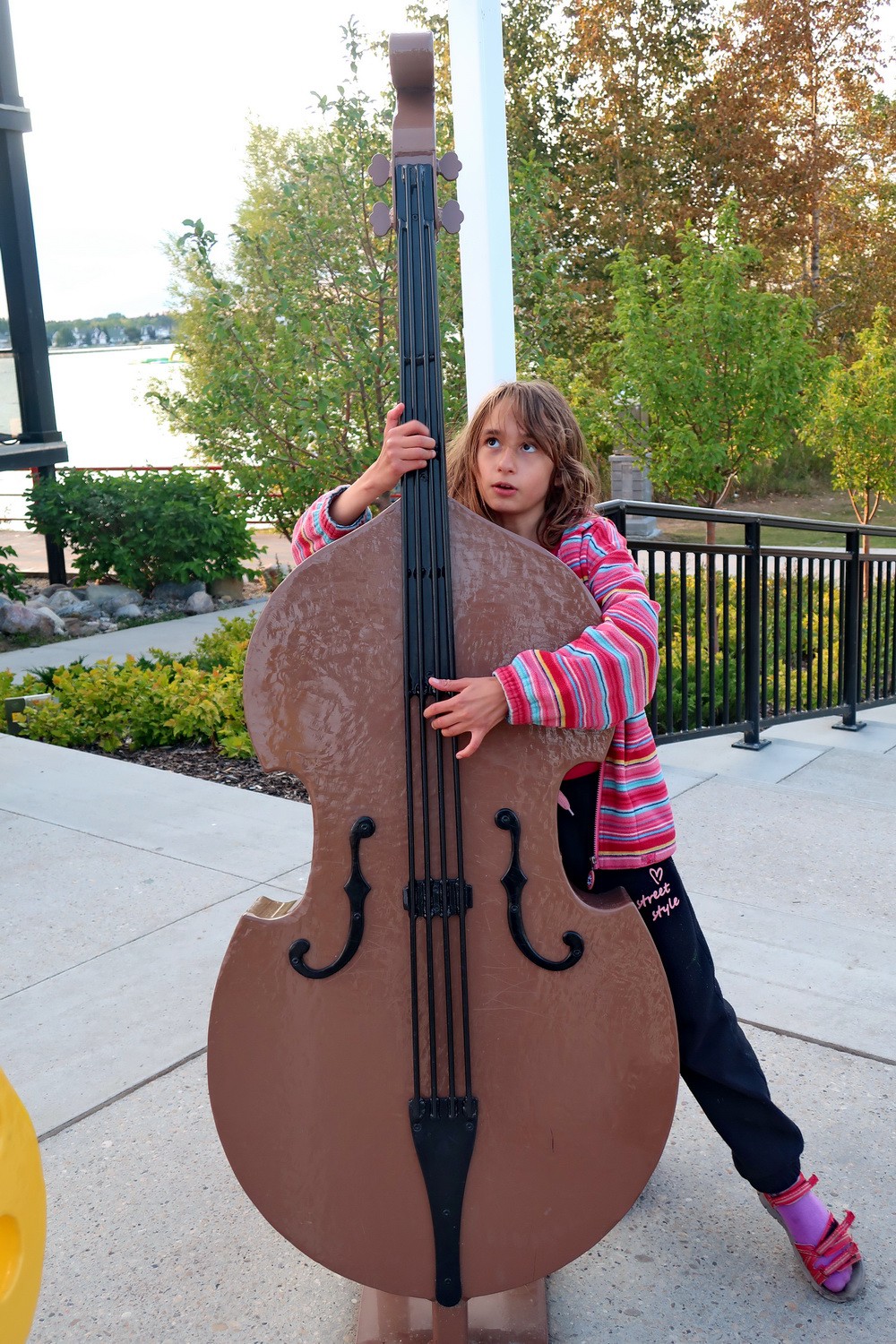 Rosemarie playing contrabass with Sylvan Lake in the background
