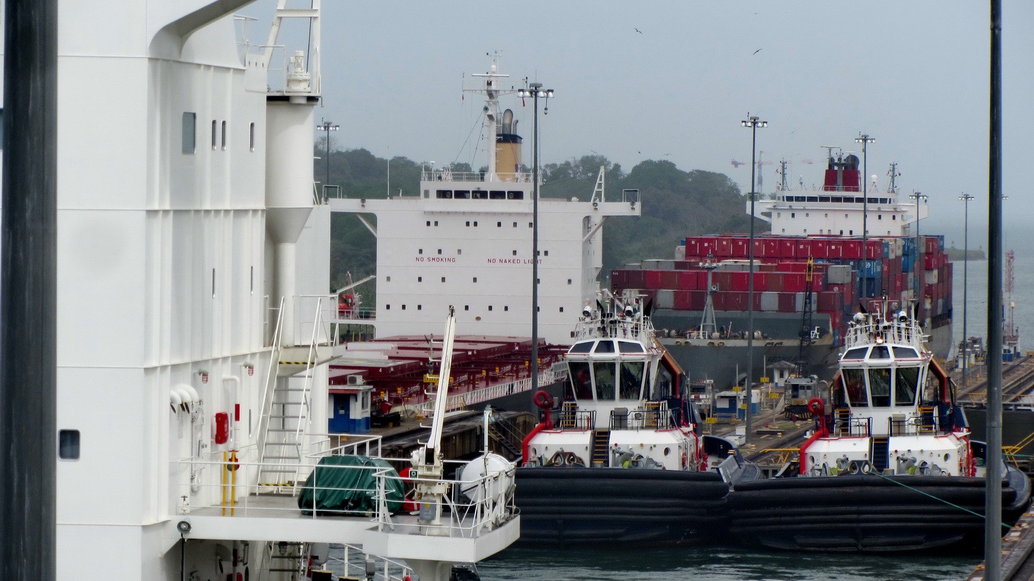 Two vessels and two pilots boats waiting on the lower Gatun lock of the Panama Canal