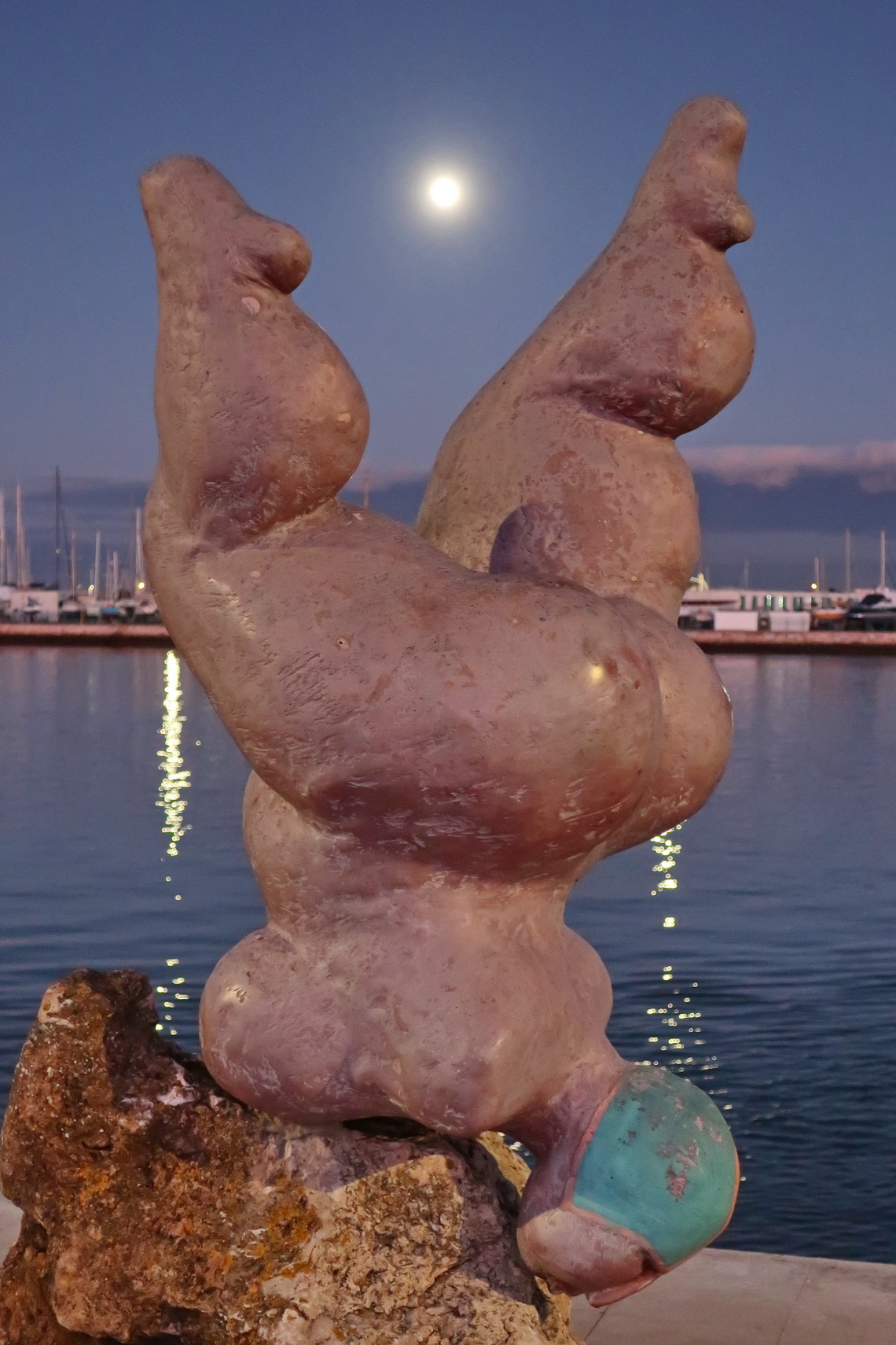 Lady with full moon in Portimão - on shore of river Rio Arade