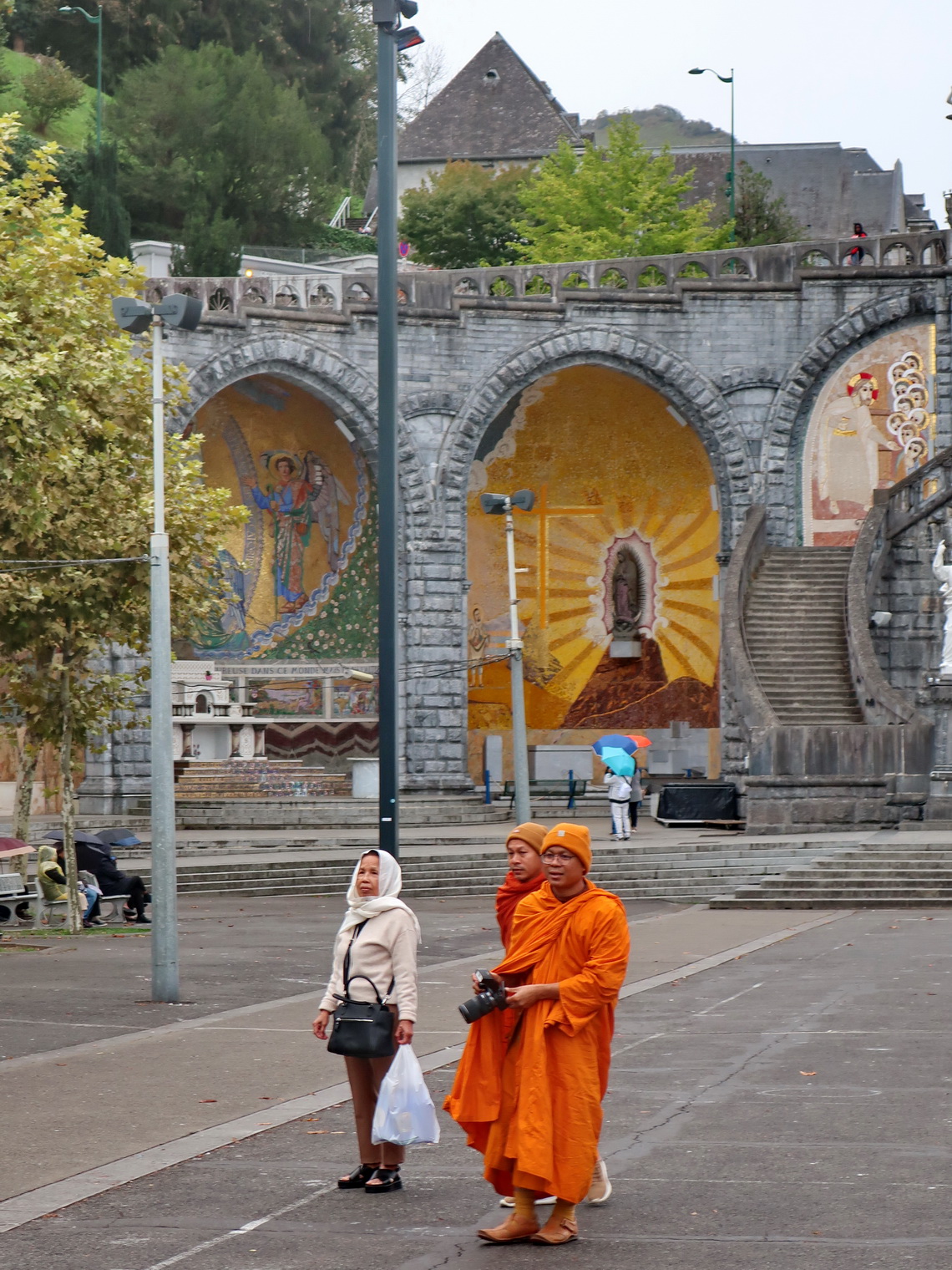 Buddhist monks in front of the chapels Saint Bernadette and Notre Dame de Guadeloupe