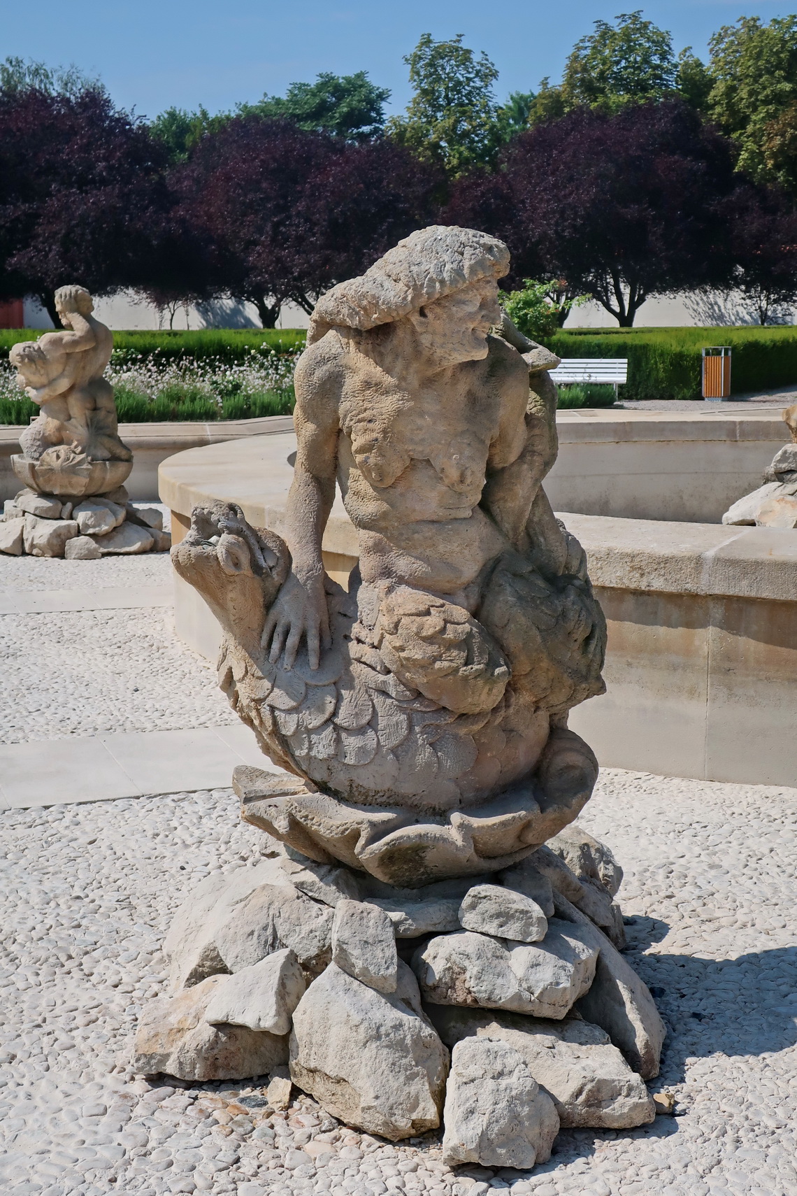 Elderly mermaid in front of the fountain of the castle Trojský Zámek