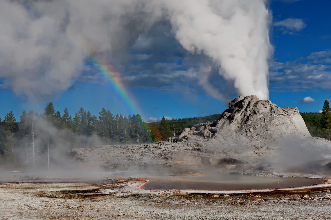 Erupting Castle Geyser with rainbow