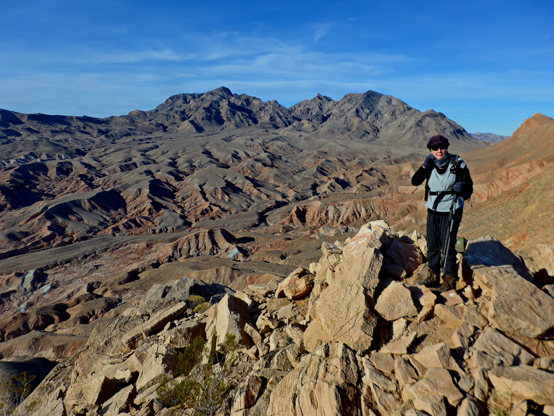 Marion on top of Anniversary Peak with Muddy Mountains in the background