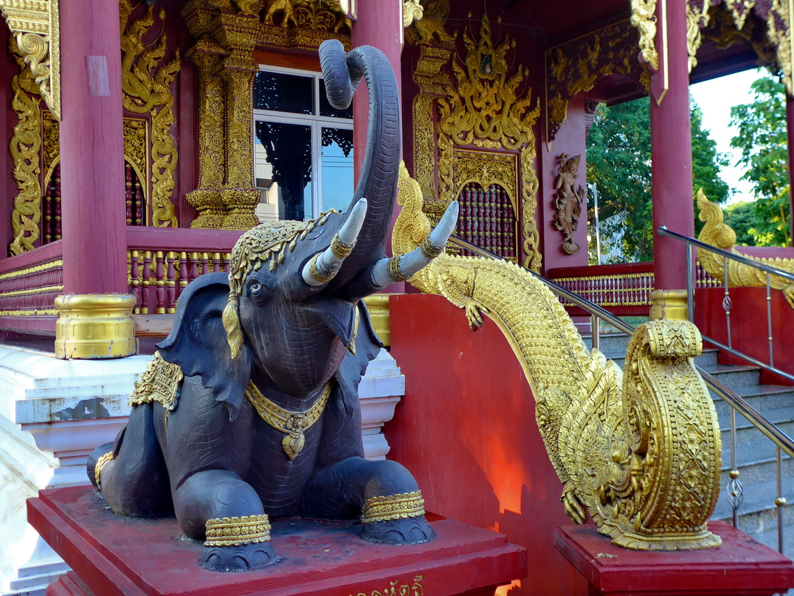 Elephant watching the entrance of the temple Wat Chedi Ngam in Fang