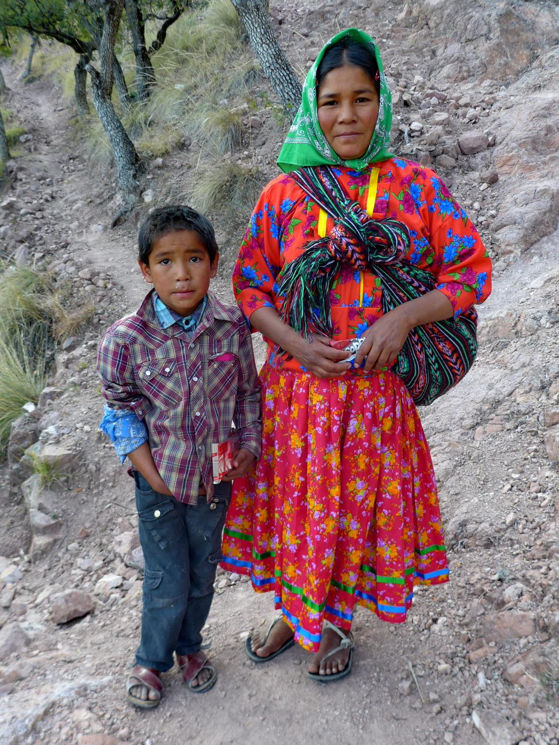 Tarahumara boy with his mother who wears a traditional costume