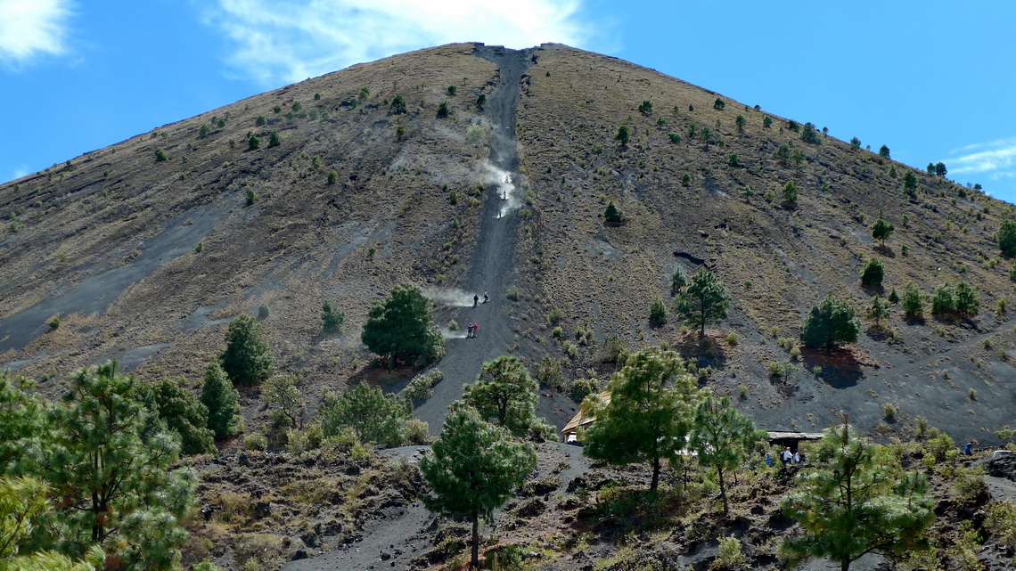 The summit cone of Volcan Paricutin with people heading down speedily in the ash and scree of the summit gully