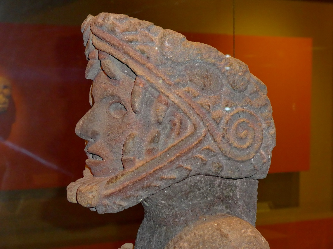 Younger man with a head with an integrated snake in the museum of Teotenango