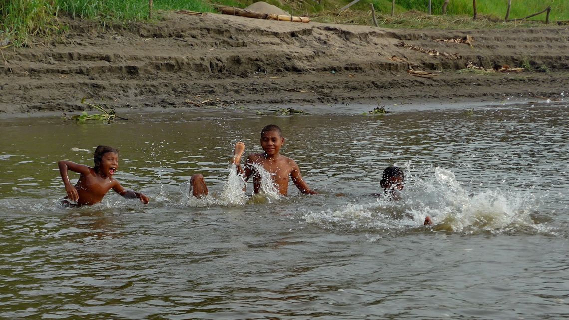 Kids enjoying the warm water of the river