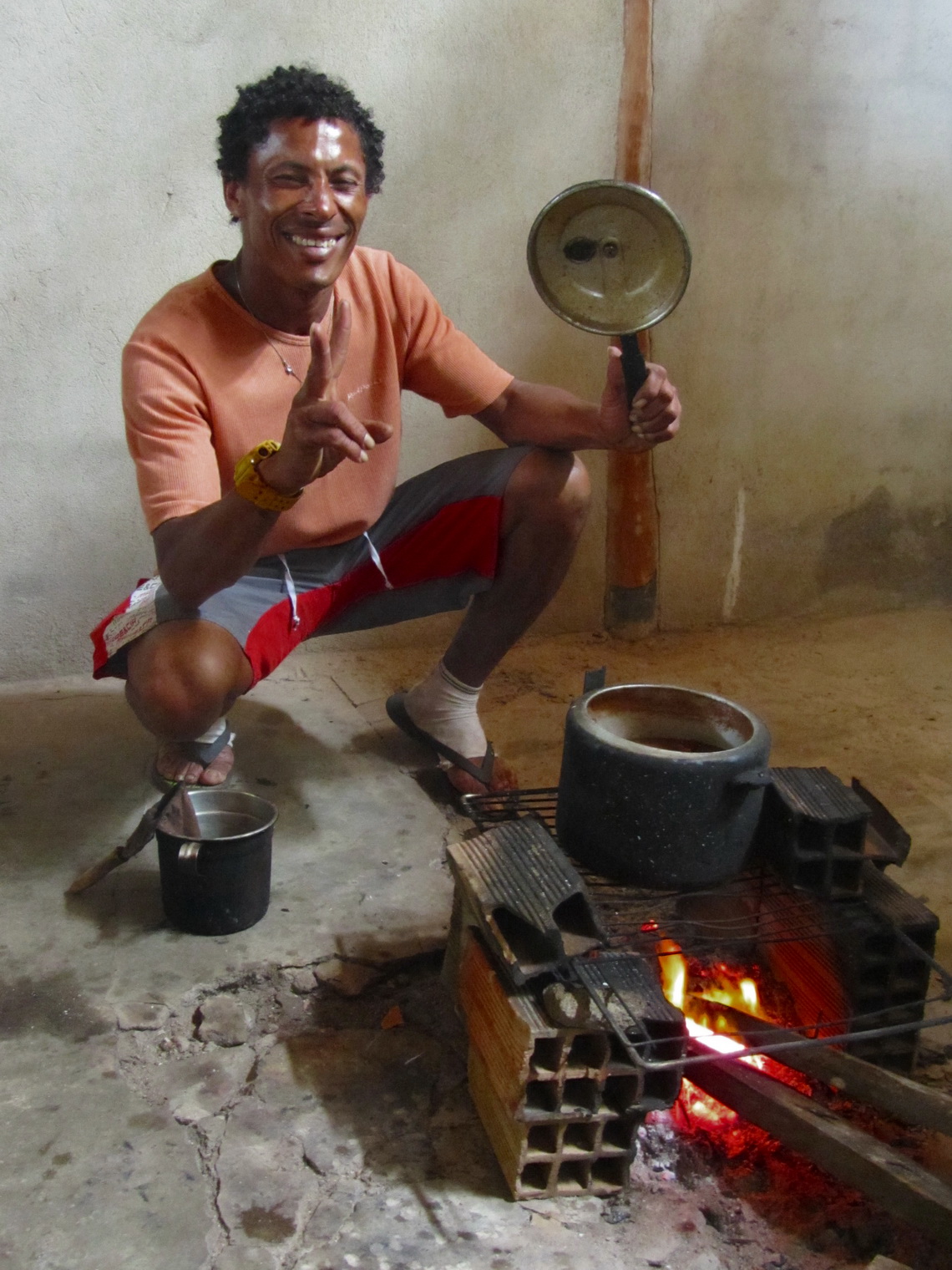Our proud chef showing the delicious chicken stew on his stove